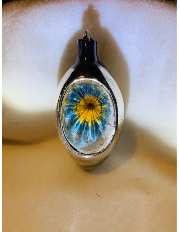 Olijf met zonnetje van het gekende Belgische merk Ajeko. 